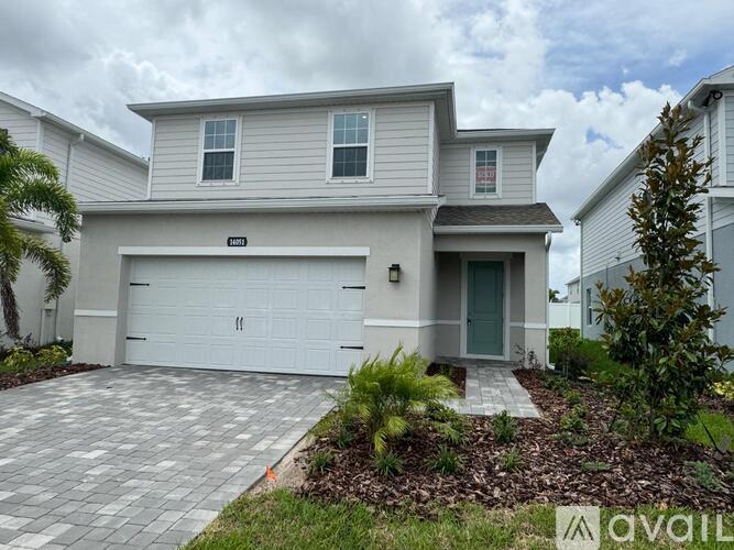 A modern house with a garage is for sale.