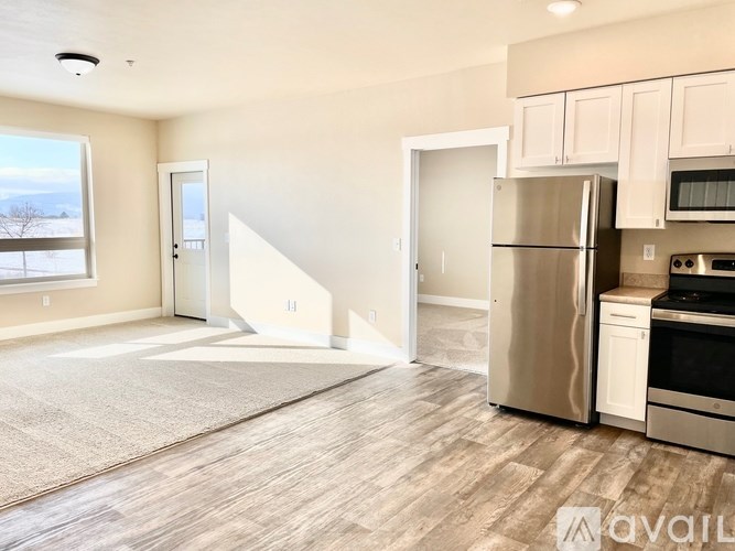 A kitchen with a refrigerator, oven, and microwave.