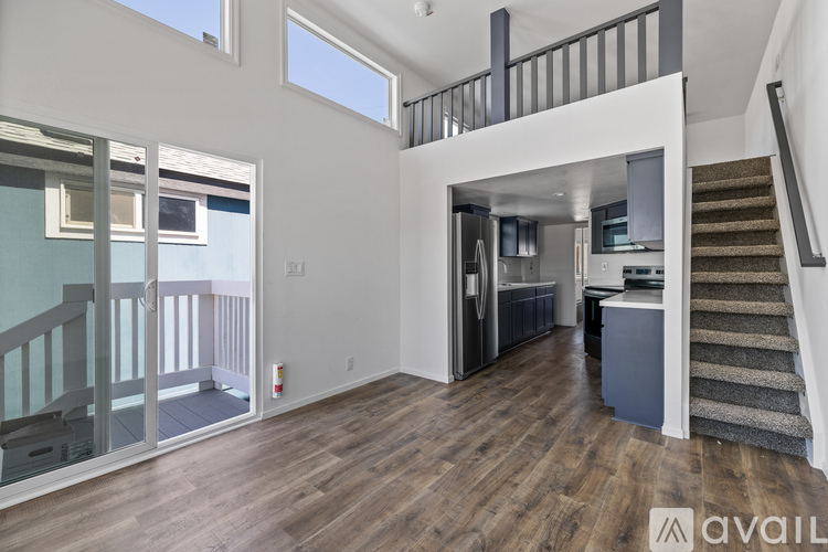 A spacious open floor plan with a staircase leading to the upper level.