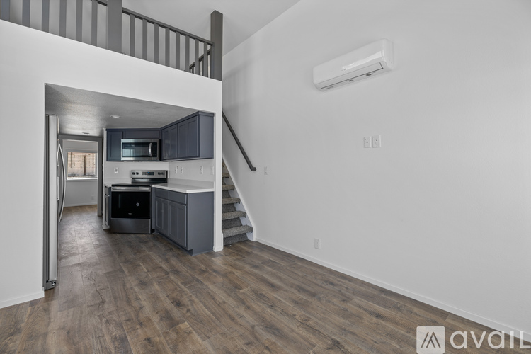 A kitchen with a staircase leading to the upper floor.