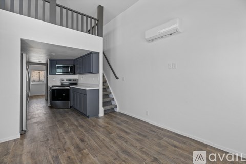 A kitchen with a staircase leading to the upper floor.