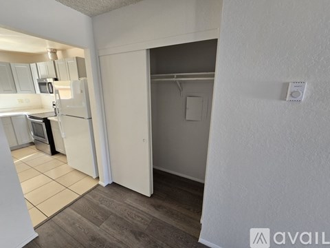 A kitchen with white appliances and a white refrigerator is shown.