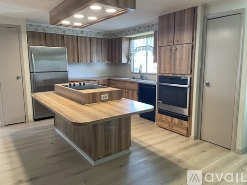 A kitchen with wooden cabinets and a central island.