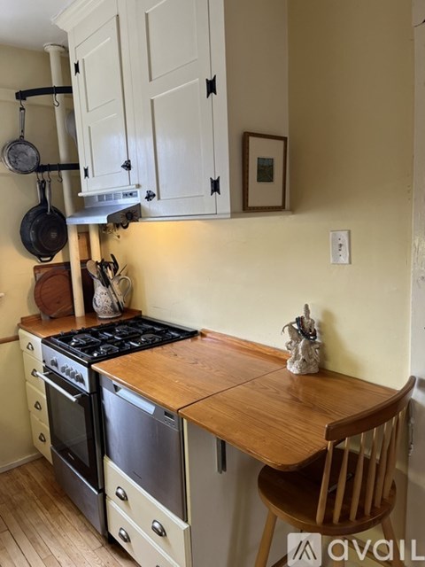 A kitchen with a wooden countertop and a stove top oven.