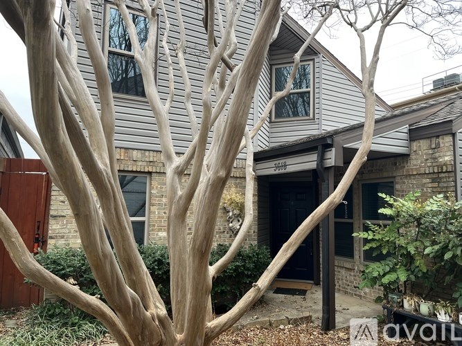A house with a tree in front of it.