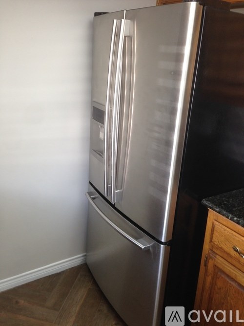 A stainless steel refrigerator with its door open.