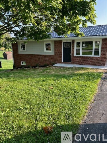 A small house with a black door and a brick exterior.