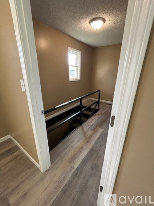 A hallway with a window and a bench.
