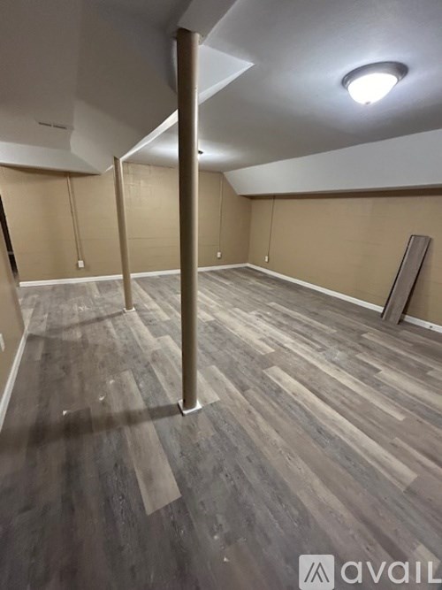 A room with wooden flooring and a white ceiling.