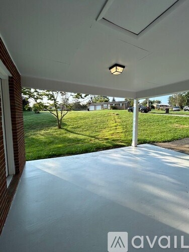 A patio with a white floor and a ceiling light.