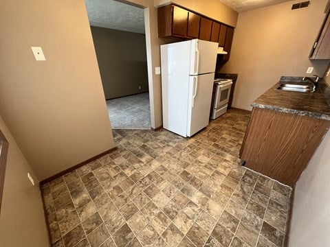 a kitchen with a refrigerator in the middle of a room