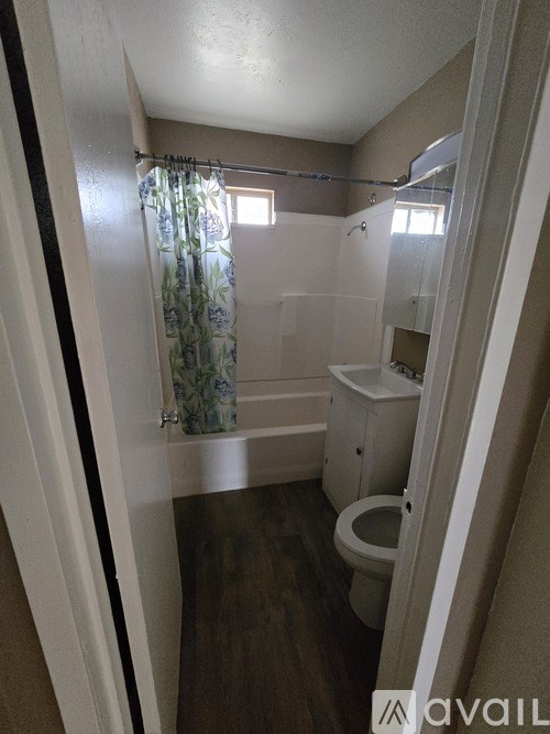 A bathroom with a toilet, sink, and shower.