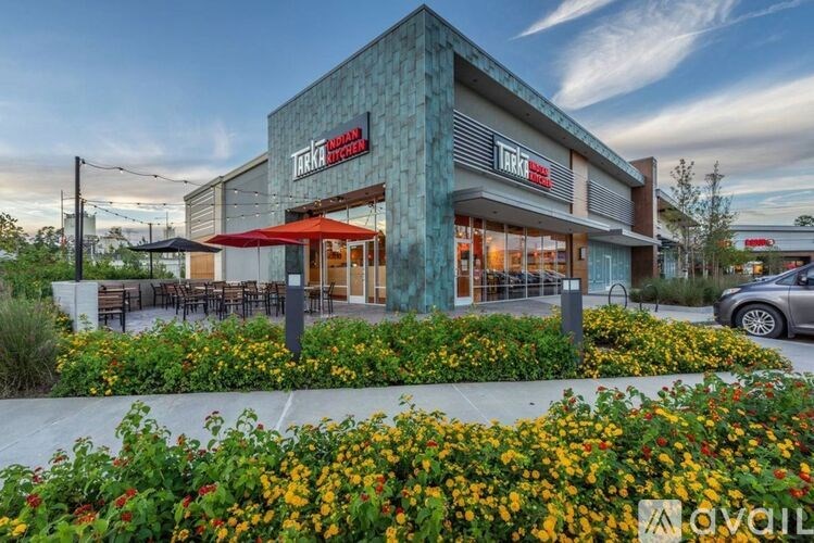 A modern building with a green facade and a sign that reads "TRAKKA".