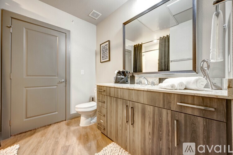 A bathroom with wooden cabinets and a white toilet.