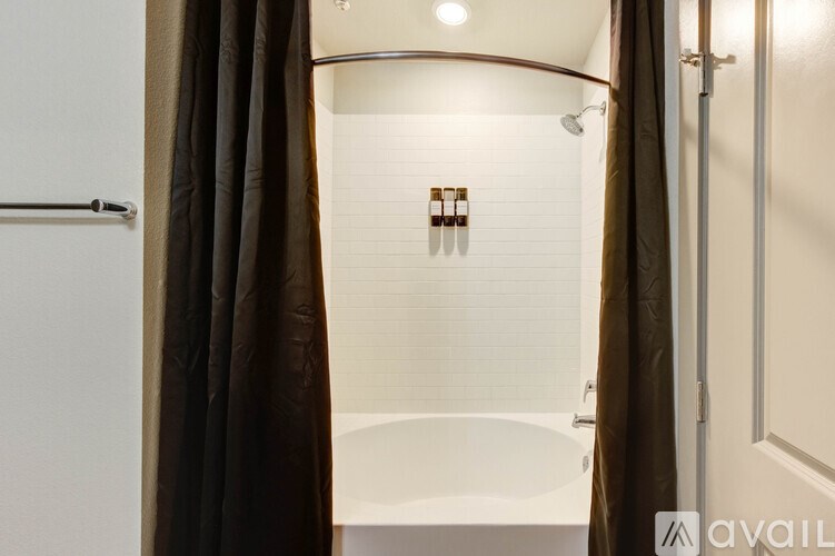 A bathroom with a tub and a shower.