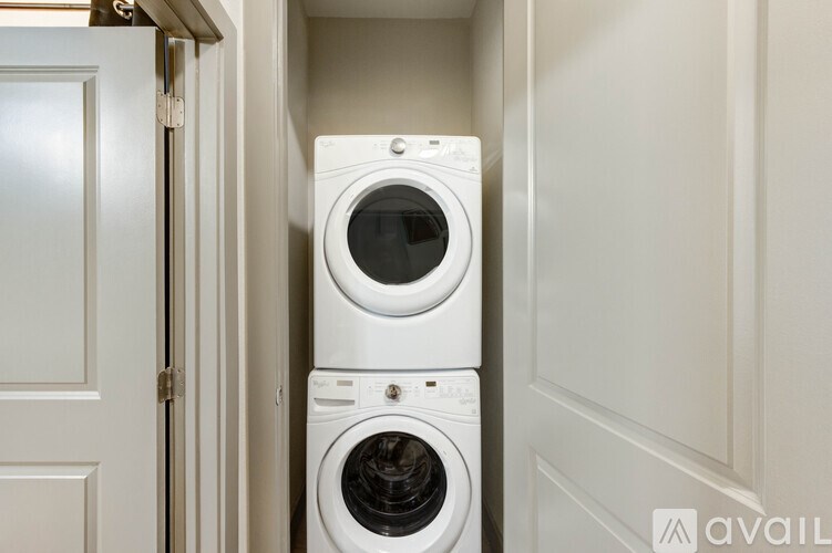 A white washing machine and dryer in a small laundry room.