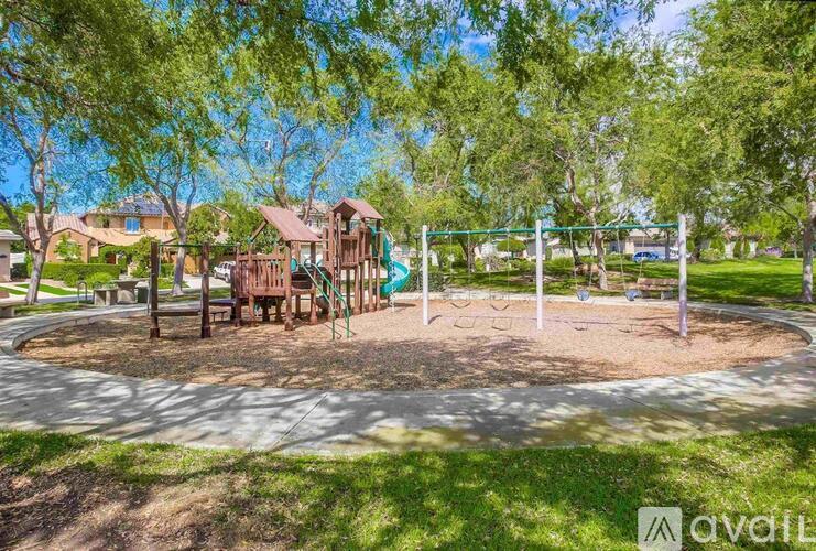 A playground with a swing set and a slide.