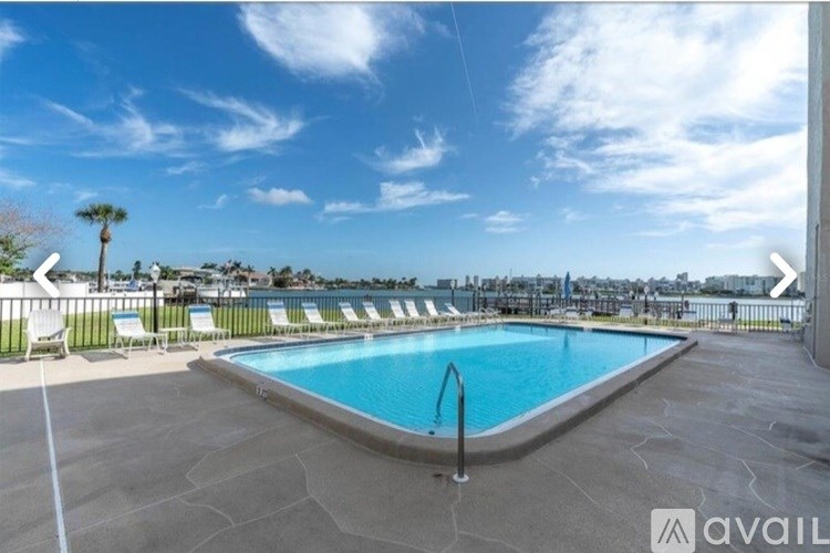 A swimming pool with a sunny sky above.