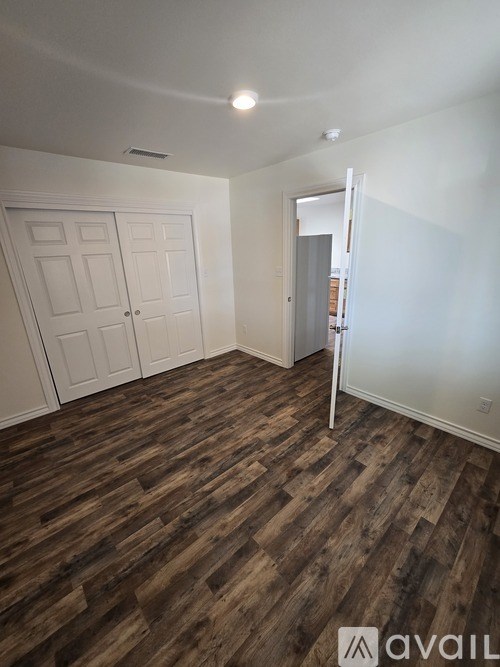 A room with a wooden floor and white walls.