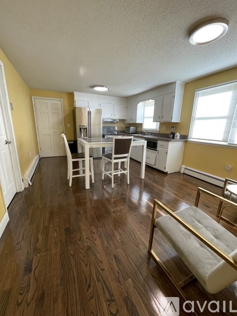 A kitchen with yellow walls and white appliances.