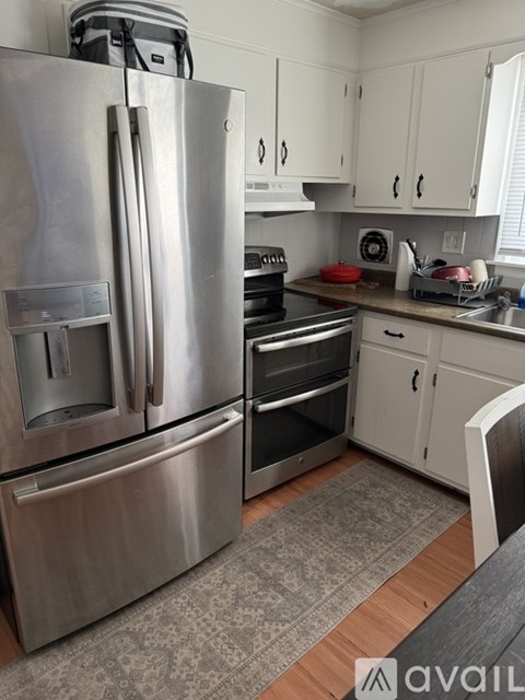 A kitchen with a stainless steel refrigerator and oven.