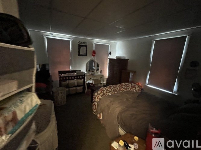 A room with a bed, a couch, and a dresser is shown.