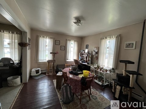 A living room with a dining table set up in the middle.