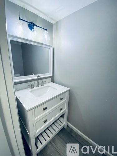 A white bathroom sink with a mirror above it.