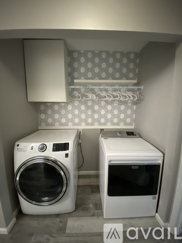 A washing machine and dryer in a small laundry room.