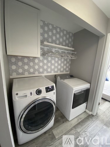 A small laundry room with a washer and dryer.