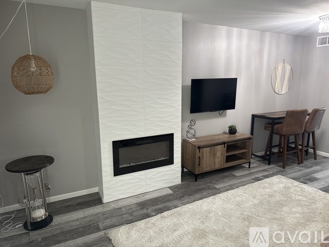 A modern living room with a fireplace and a television.