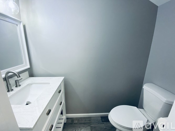 A white sink and toilet in a small bathroom.