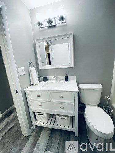 A white bathroom with a toilet and sink.