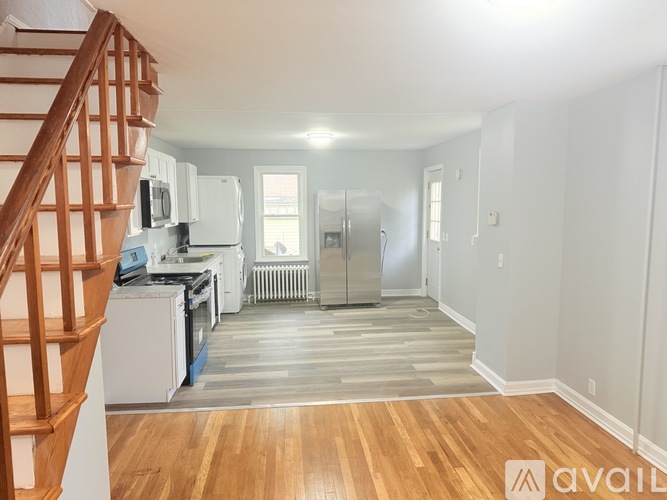 A kitchen with a refrigerator, stove, and oven.