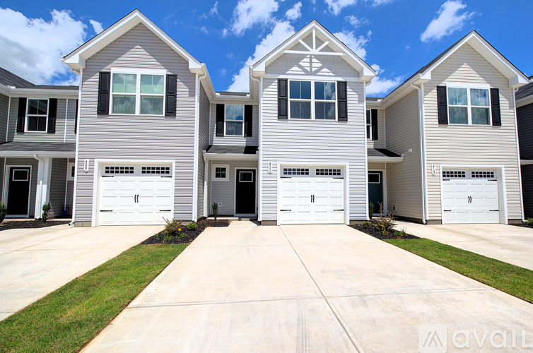 A row of houses with garages in front.
