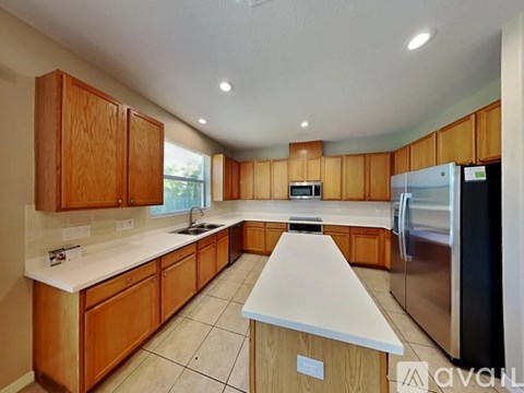 A kitchen with wooden cabinets and a white countertop.