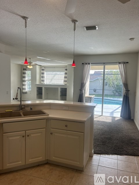 A kitchen with a sink and a window.