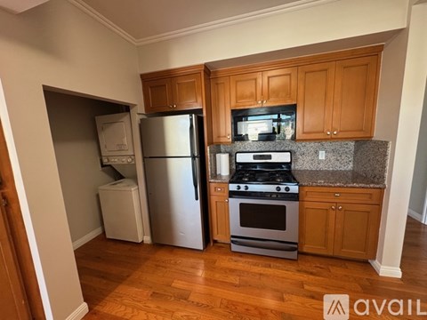 A kitchen with wooden cabinets and a granite countertop.