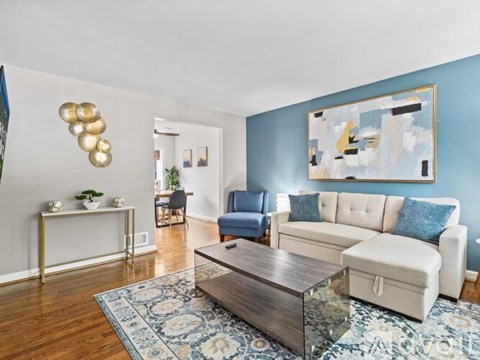 A living room with a white couch and a coffee table.