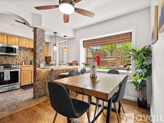 A modern kitchen with a dining table and chairs.