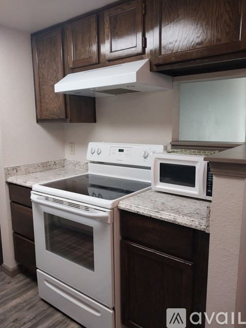 A white oven and microwave are on a kitchen counter.
