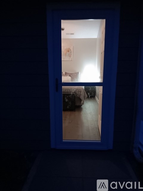 A blue frame with a mirror inside showing a bedroom.