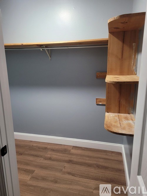 A wooden shelf with a cloth hanging on it.