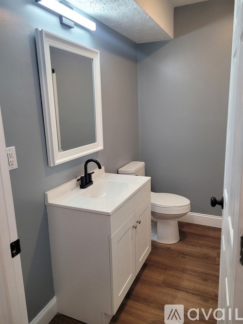 A small bathroom with a white sink and toilet.