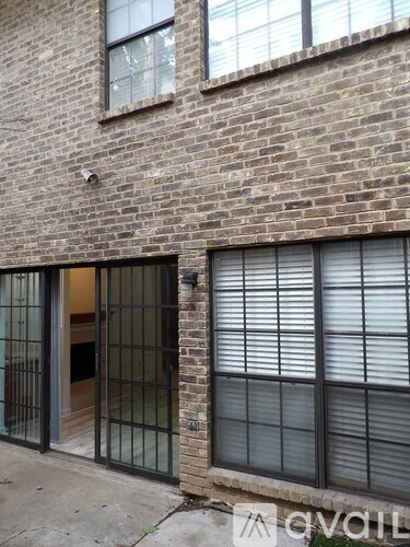 A brick building with a window and a door with a window.