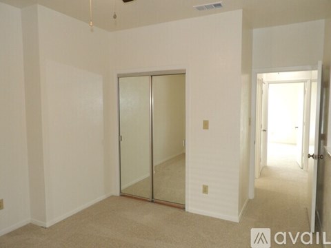 A room with a glass door and carpeted floor.
