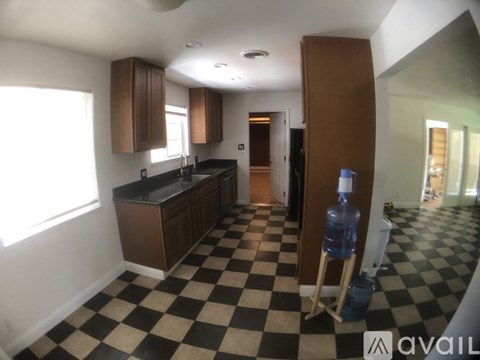 A kitchen with black and white checkered floor.