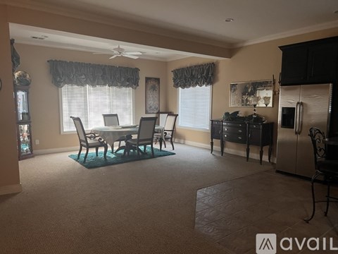 A living room with a dining table and chairs.