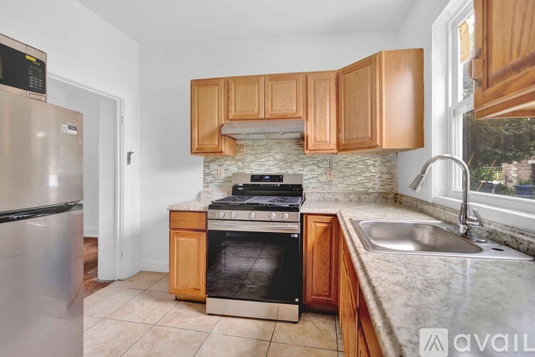 A kitchen with wooden cabinets and a stove top oven.