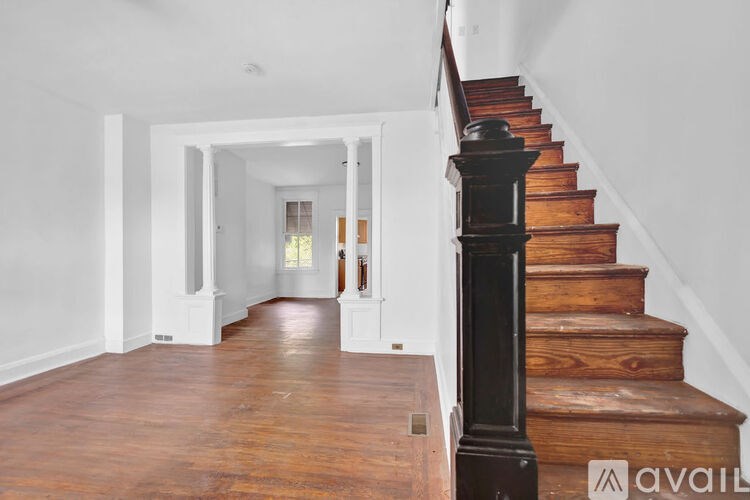 A long hallway with a staircase on the right side.